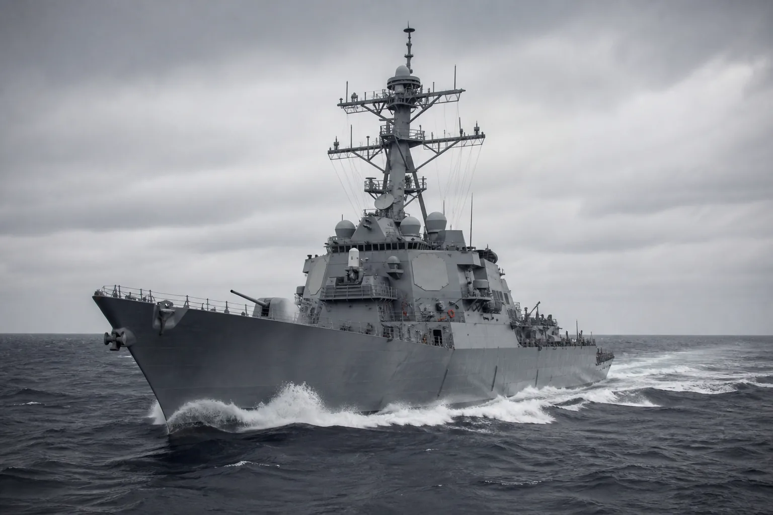 A grey guided-missile destroyer under way in open ocean, bow wave breaking, under heavy overcast (AI-generated image)