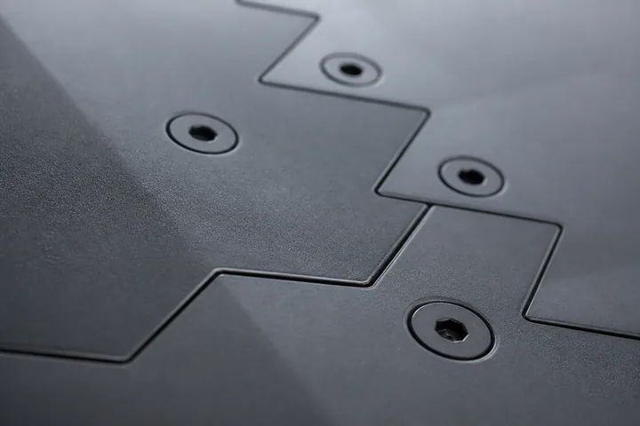A stealth fighter's serrated panel edges and flush fasteners seen very close (AI-generated image)