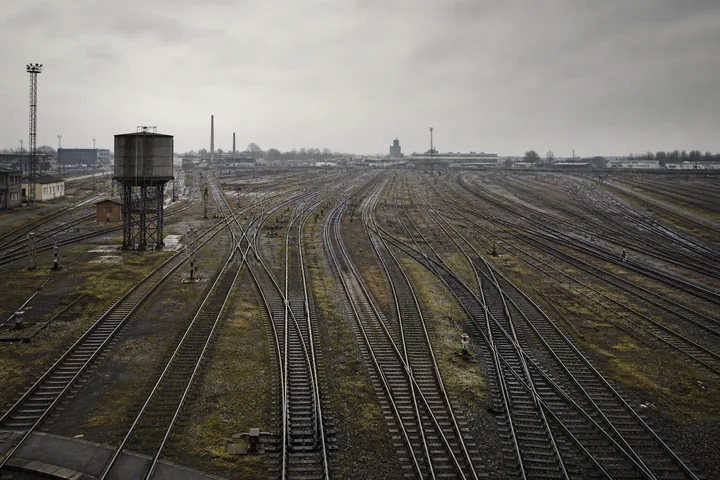 A railway marshalling yard from elevation: parallel tracks, points and a water tower (AI-generated image)
