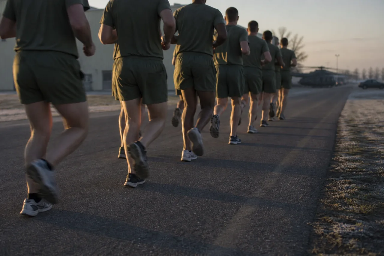 Recruits in physical training uniforms running in formation on a base road at dawn (AI-generated image)