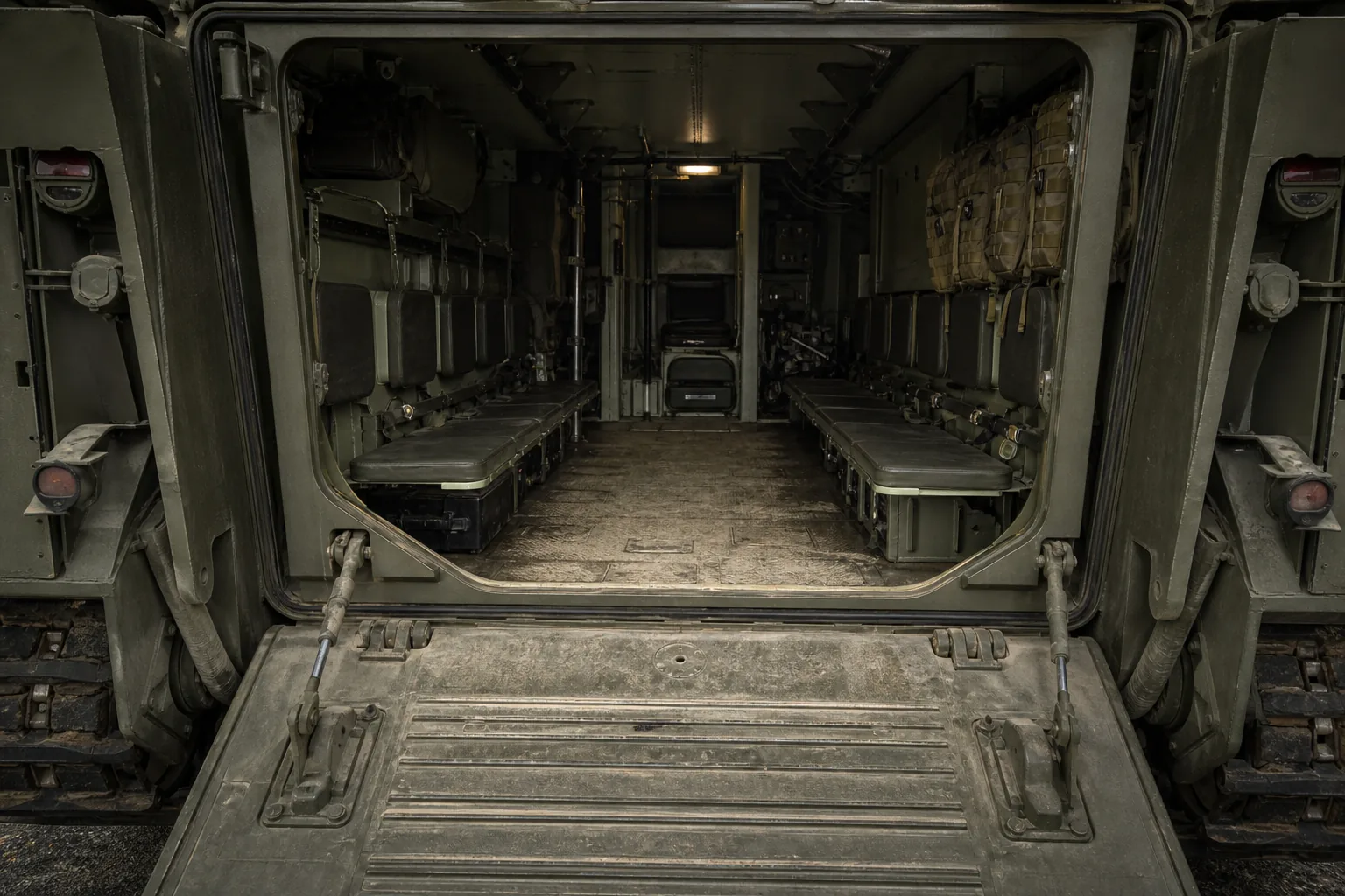An infantry fighting vehicle's open rear ramp and troop compartment with bench seats and stowage (AI-generated image)